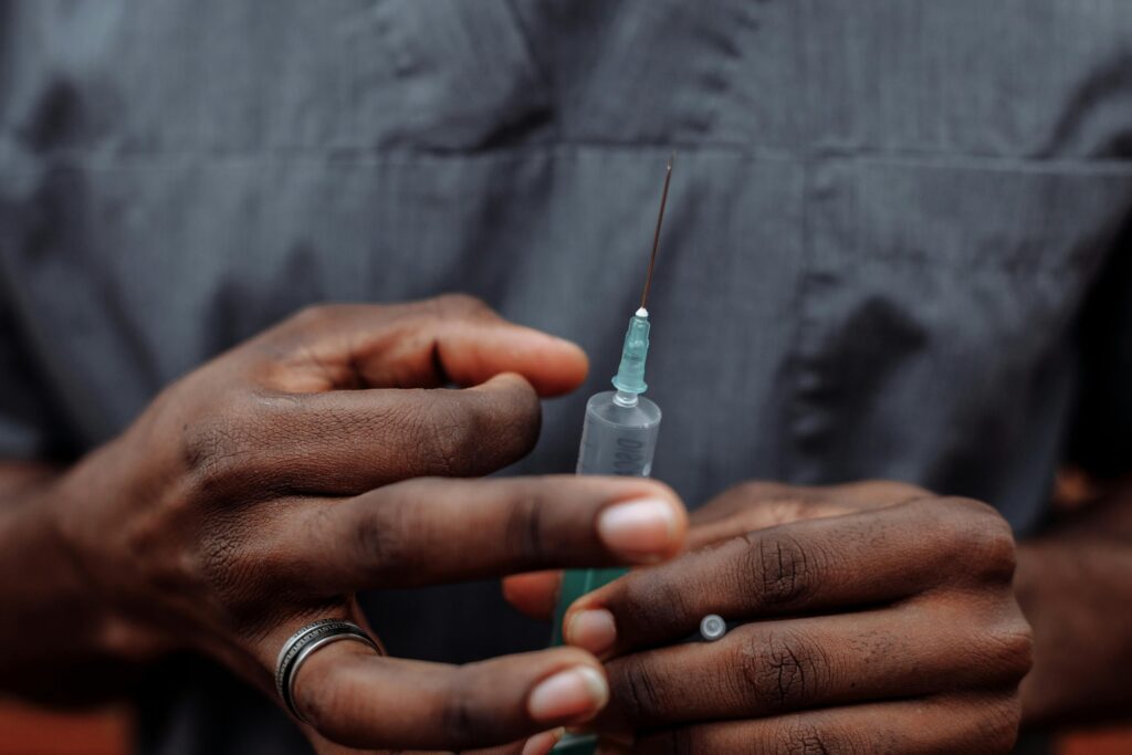 A close-up shot of a medical professional holding a syringe, highlighting healthcare and medical procedures.
